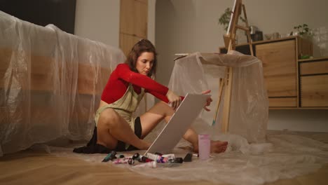 woman painting in home studio