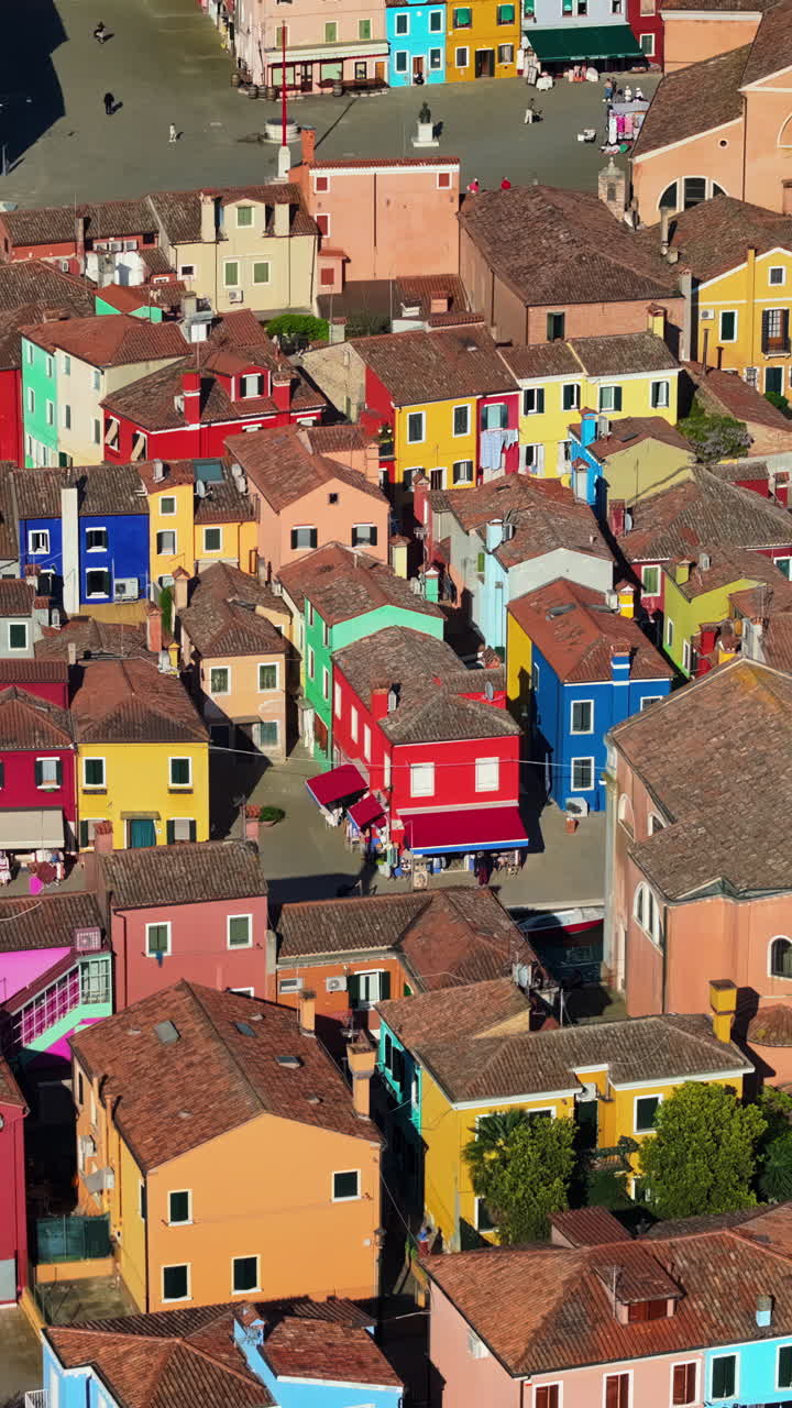 Aerial drone view of the colourful houses of Burano Island, Italy. Vertical