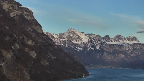 Drone-shot-of-Walensee-in-Switzerland---mountains-with-snow-and-a-blue-lake