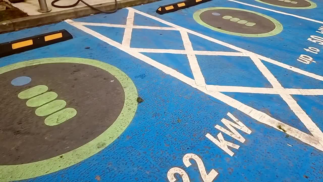 Electric vehicle power charging station point asphalt marking signs on the ground
