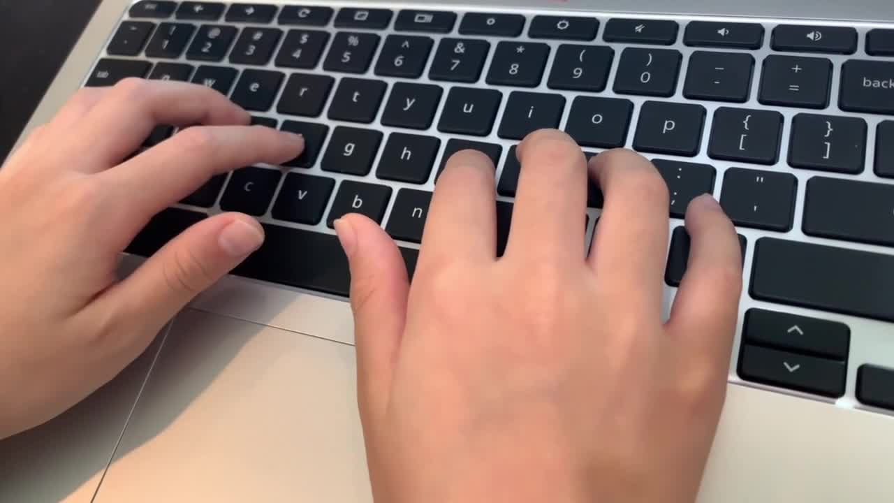 4K stock footage of child hands typing on a chromebook keyboard. Distance Learning. Online Education. Close-up on hands and keyboard. Top View looking down.