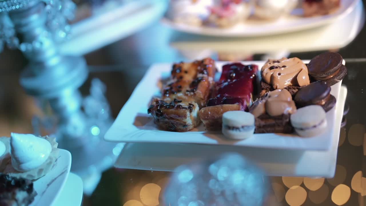 Elegant dessertbord med gourmet-desserter serveret på hvide tallerkener ved en buffet