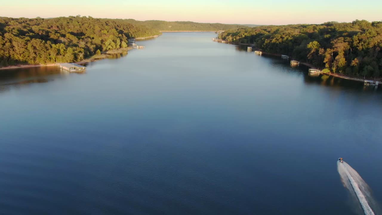 aerial view of jet ski on the lake in the early evening