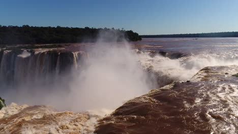 the ultimate image of iguazu falls: a captivating blend of cascading water, vibrant rainbows, and graceful birds