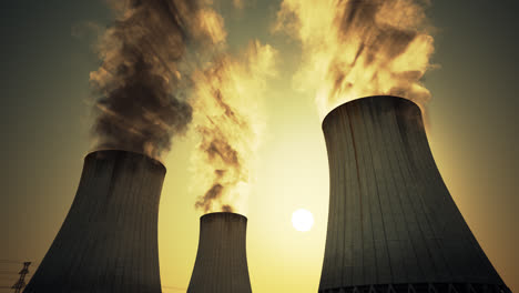 Nuclear-power-plant-caution-sign-and-barbed-wire-mounted-at-the-foot-of-three-large-tall-cement-chimneys-exhausting-smoke-and-fumes-into-the-atmosphere,-Sunset.