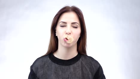 in a schoolyard a young biracial girl blowing bubbles yellow background in a schoolyard a young biracial girl blowing bubbles yellow background she has long dark hair wears striped clothing and stylish round sunglasses unaltered slow motion