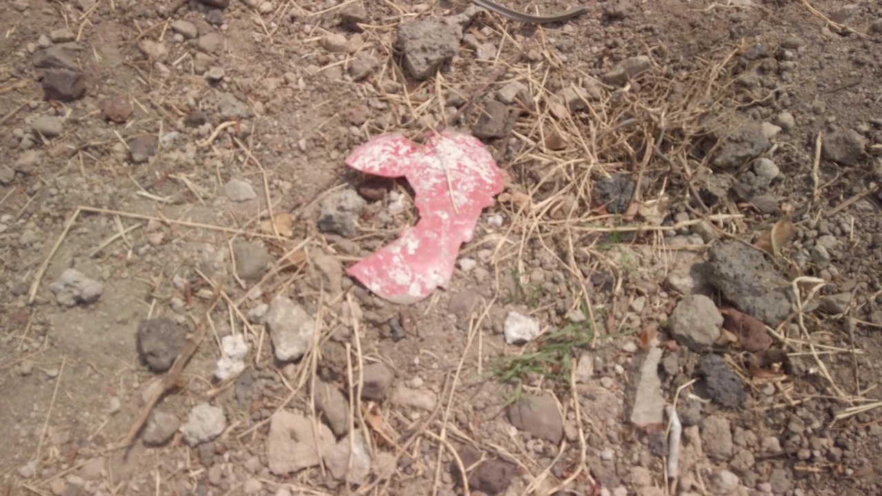 Piece of plastic on the dirt at a playground