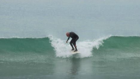 surfer catching and riding a wave