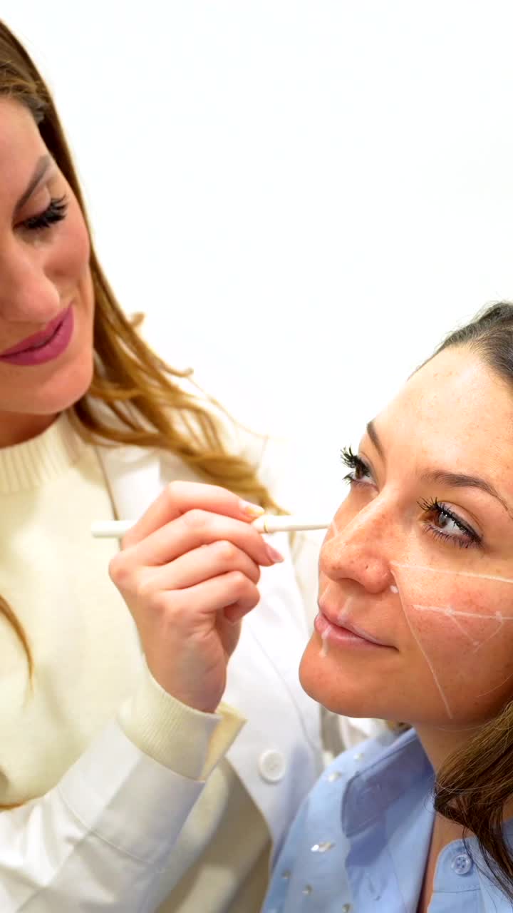 Cosmetic procedure being performed on a woman's face