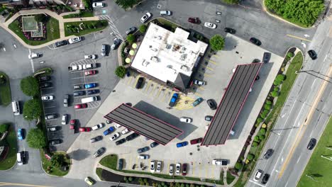 Top-down,-looking-down-while-rotating-above-Service-Station-as-vehicles-queue-at-USA-gas-station