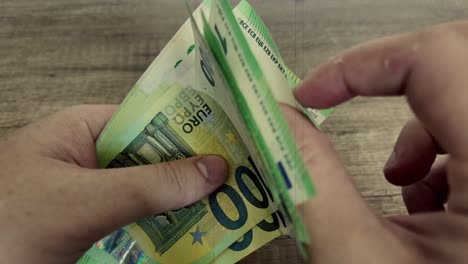 A-man-hold-euro-banknotes,-old-age-film