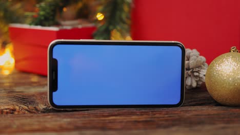 christmas background red gift box tablet gadget green screen wooden table lights