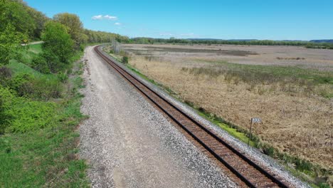 Steam Train on a Scenic Railroad Track through a Marsh and Countryside