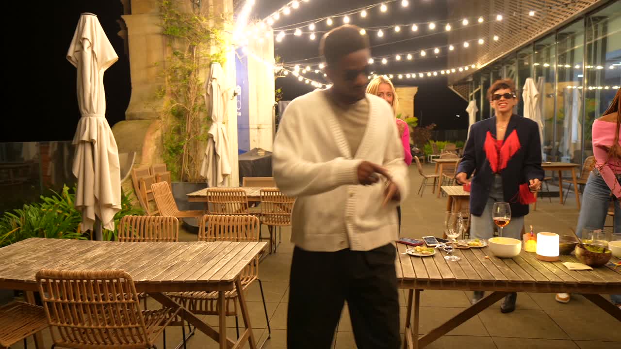 Group of friends dancing at an outdoor party