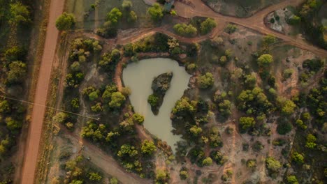 small round shaped pond in the middle of african countryside landscape