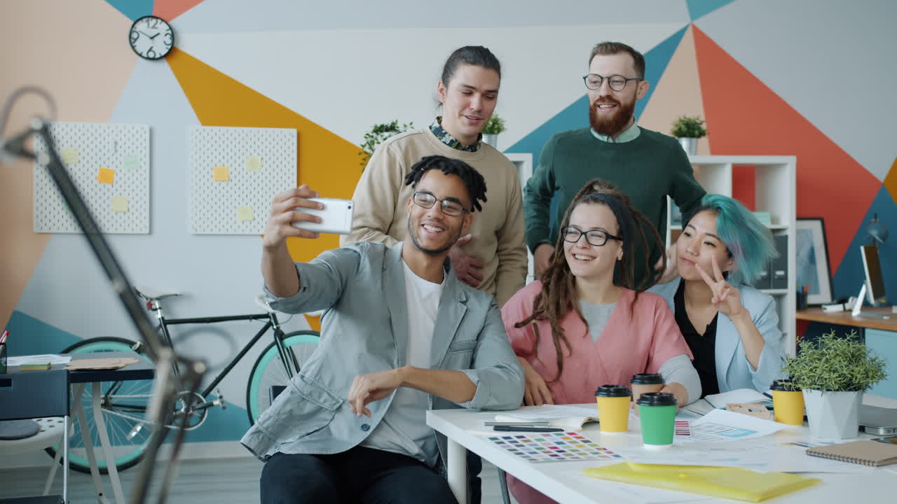 Happy Team Taking a Selfie in the Modern Office
