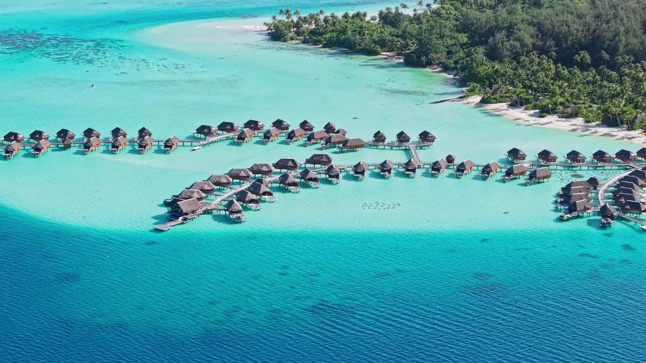 Bora Bora, French Polynesia. Drone Shot of Luxury Bungalows of Hotel Resort Above Turquoise Lagoon Water