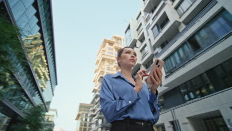 lady using smartphone map at modern urban district close up. woman browsing