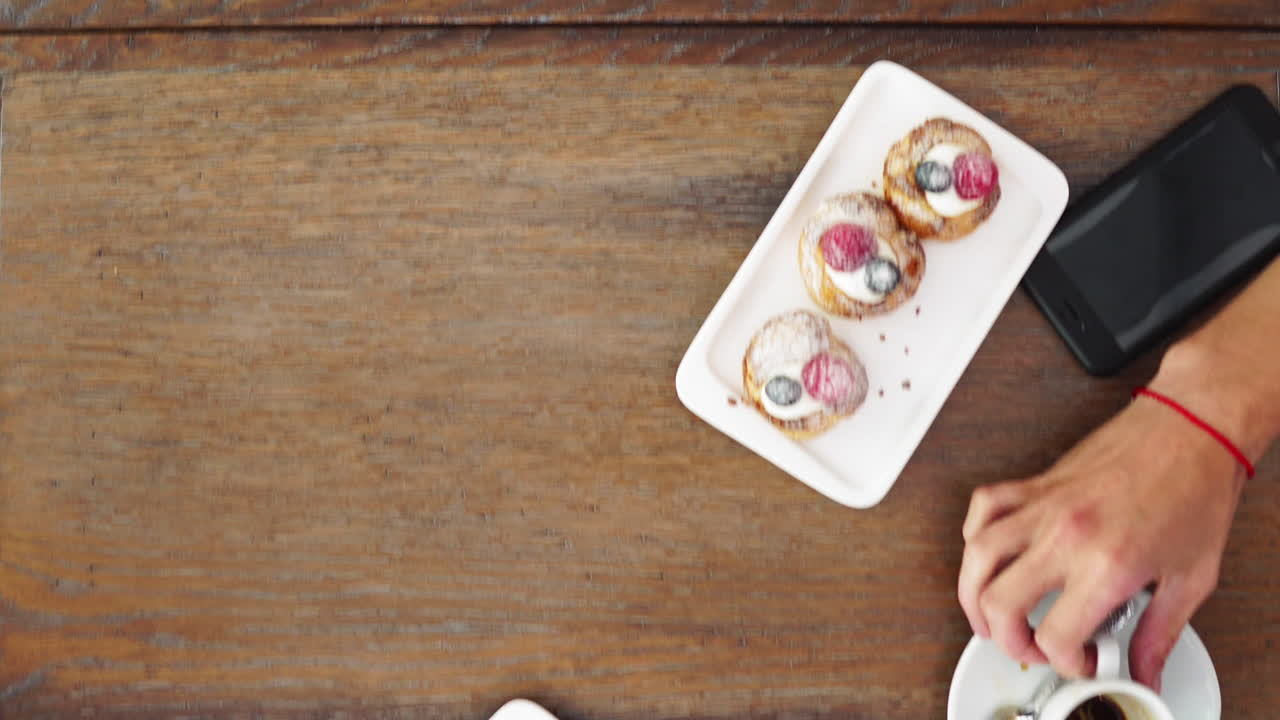 Freshly baked blueberry muffins in a rustic setting with milk and coffee on the table overhead shot with copyspace