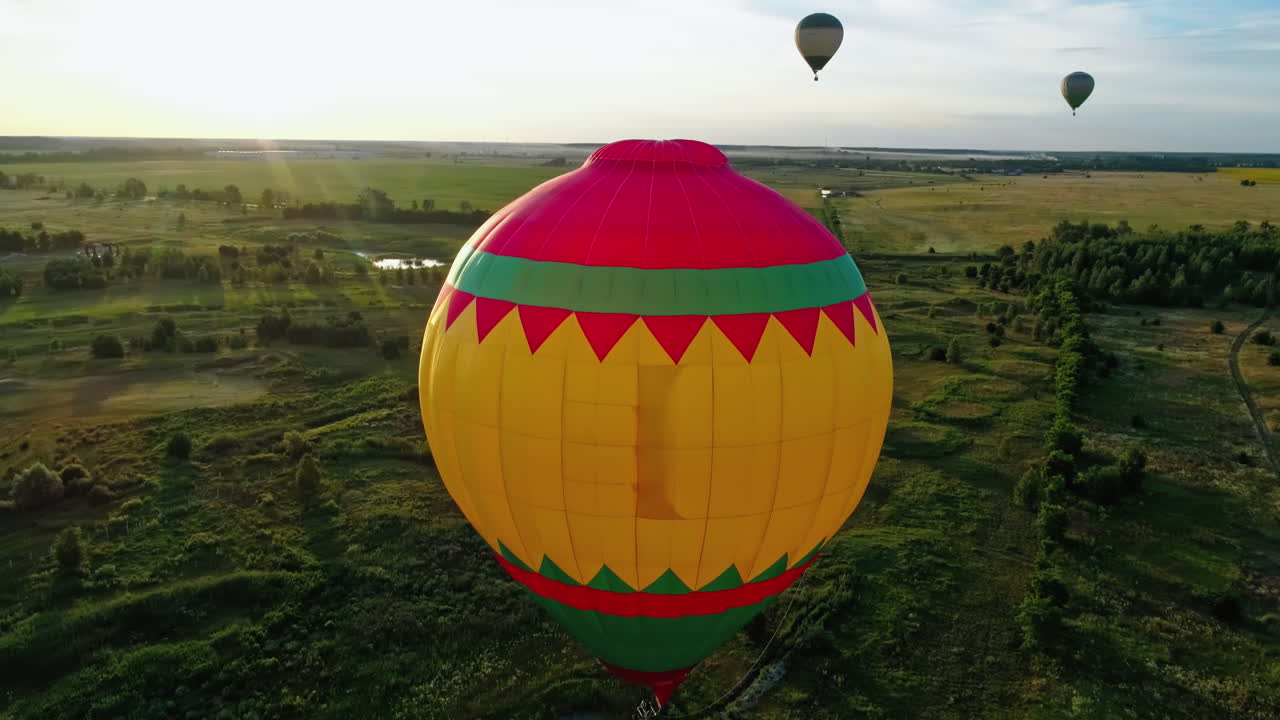 Flight By Hot Air Balloon. Colorful hot air balloon flying over fields