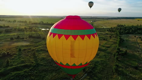flight by hot air balloon. colorful hot air balloon flying over fields