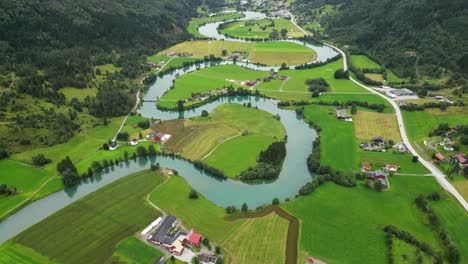 stryn river and green valley at nordfjord, vestland, norway, scandinavia - aerial reveal tilting up