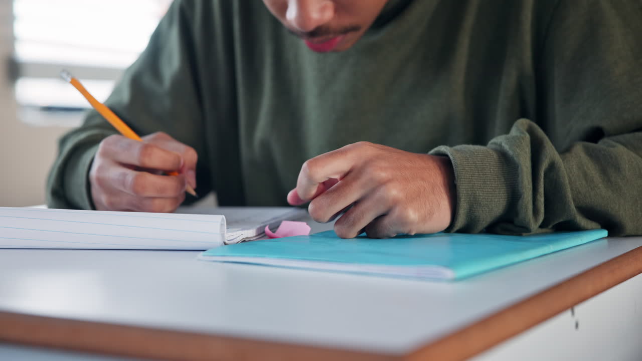 A student studying with a pencil and eraser