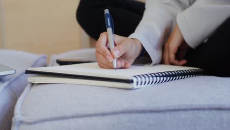 person writing in a notebook