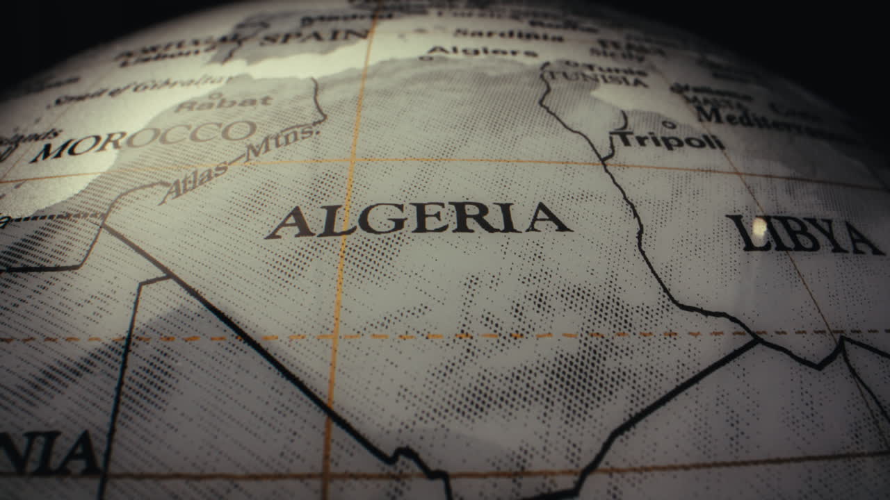 Close-up of a vintage world globe, focusing on the region of Algeria, Morocco, and Libya