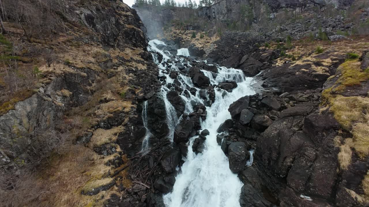 FPV Drone Shot of Latefossen Waterfall from Gronsdalslona River Rapids, Norway, Ascending Aerial View
