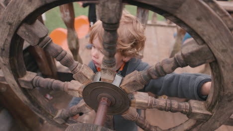 young child with a pirate ship wheel - imagination playing make believe