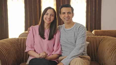 Cute-and-happy-Indian-middle-aged-couple-smiling-to-the-camera