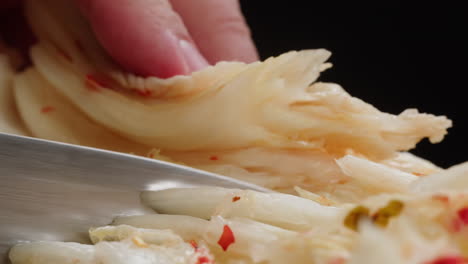 close-up of texture fermented spicy cabbage kimchi with in can. preservation of vegetables in glass jars. fermentation preserved kimchi cabbage with spices macro. asian cuisine. high quality 4k footage