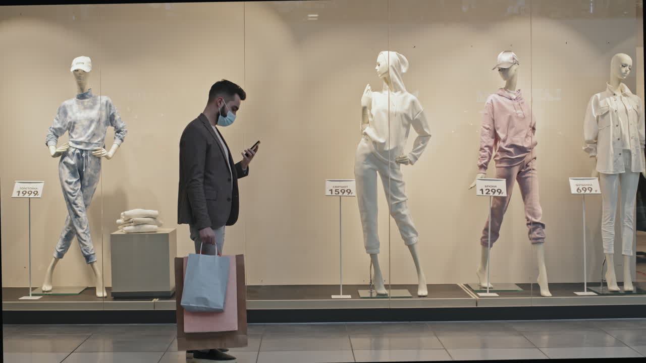 Man Taking Picture Of Mannequin At Shopping Centre