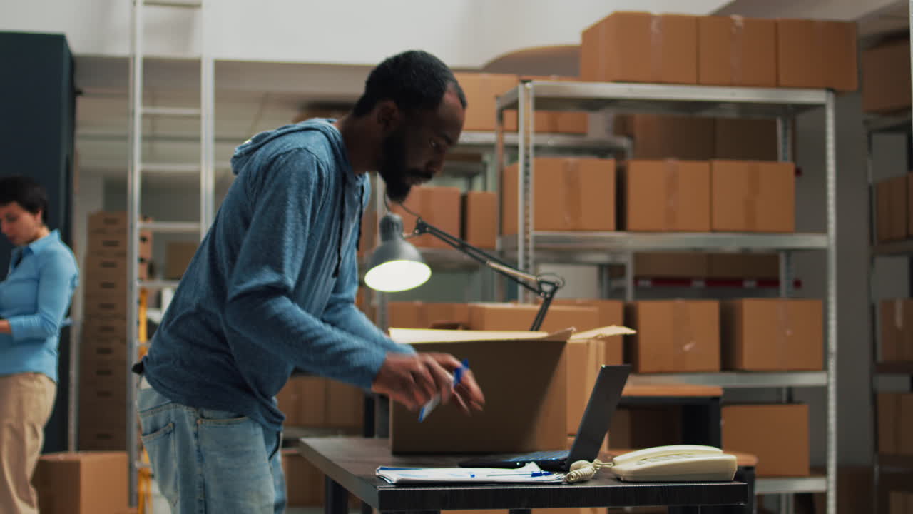 People working in a warehouse packing boxes