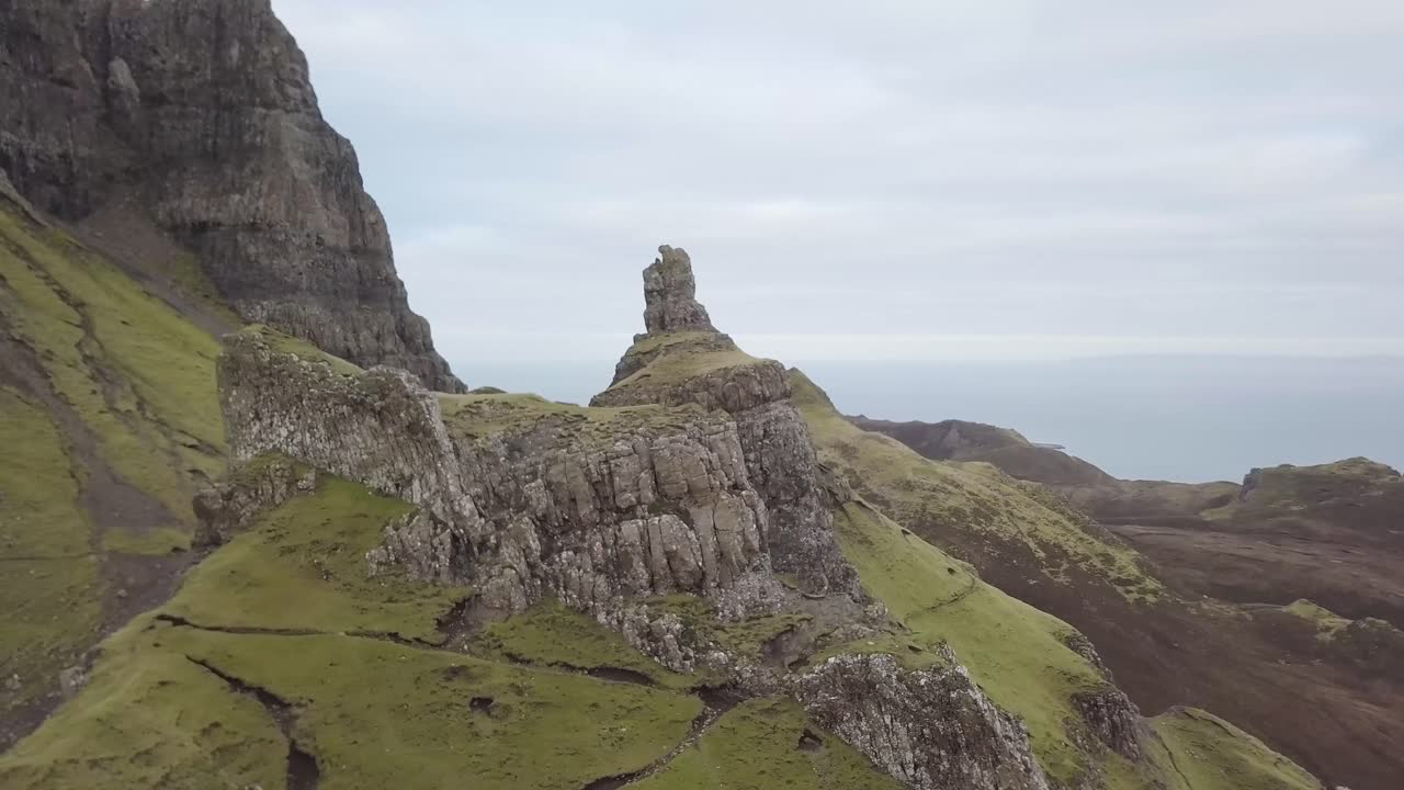 An aerial video flying over the Quiraing on the Isle of Skye in Scotland. Its an overcast day and it is orbiting the land slip and rock features.