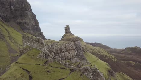 an aerial video flying over the quiraing on the isle of skye in scotland. its an overcast day and it is orbiting the land slip and rock features.