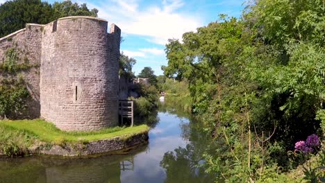 The-Bishop's-Palace-and-Gardens,-medieval-historic-castle-palace-with-moat-near-Wells-Cathedral-in-Somerset-UK