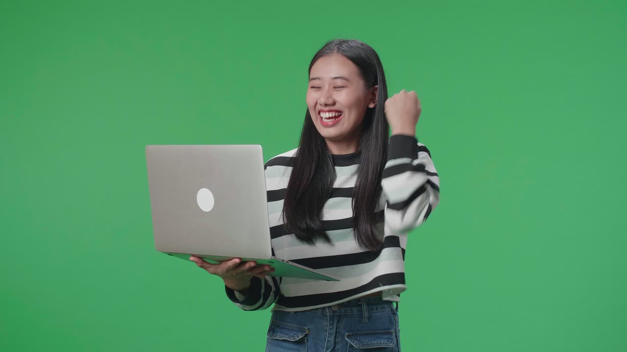 Happy Woman Celebrating Success on Laptop