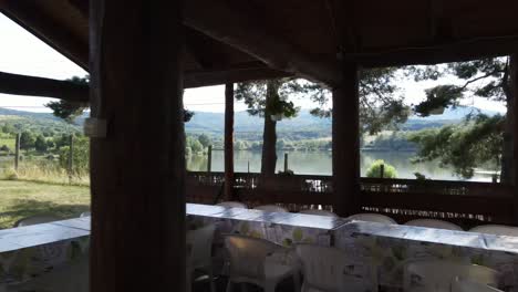 tables set up for event in outdoor shelter, view of lake, varbo, hungary