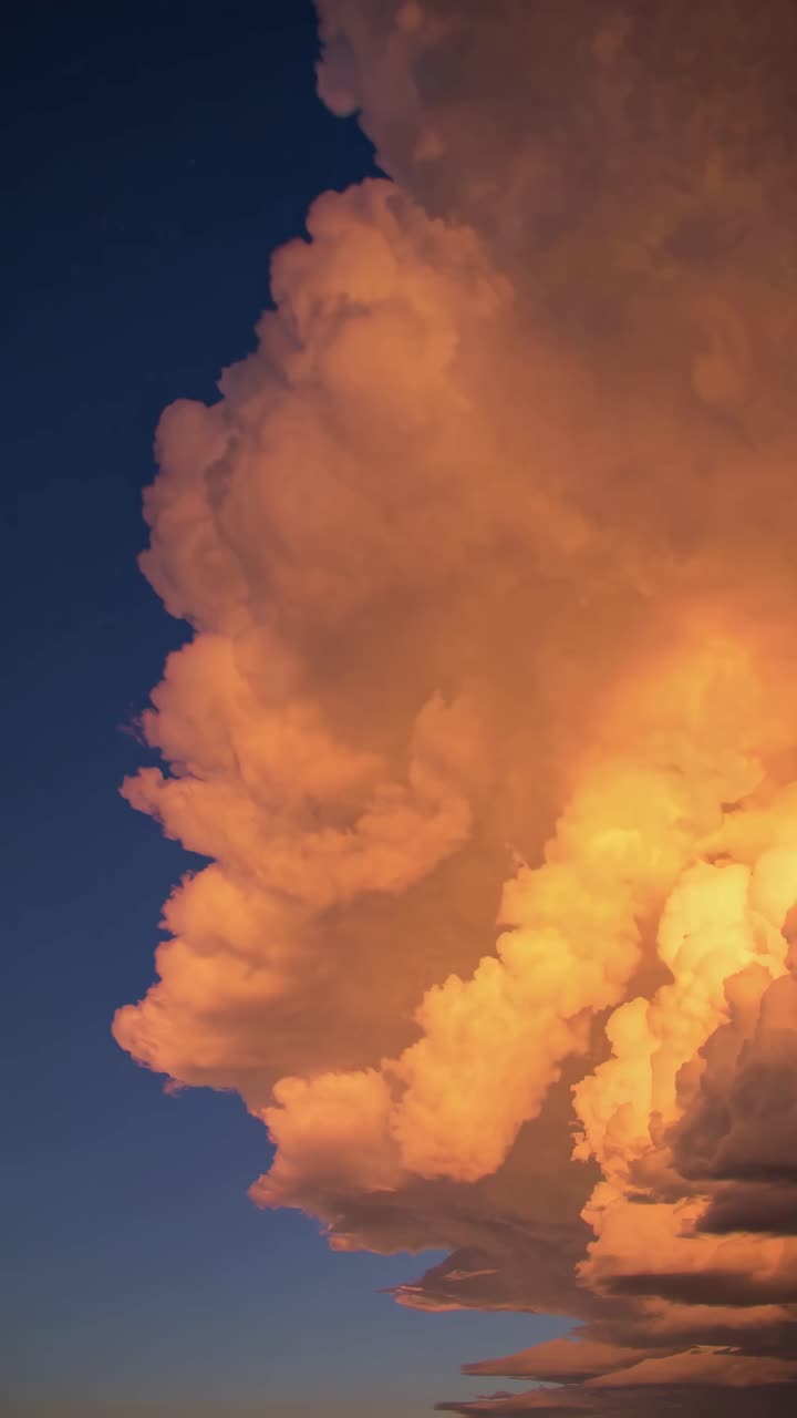 Dramatic Golden Clouds Moving Across a Dark Blue Sky