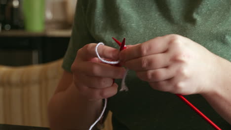 close-up shot of a caucasian woman knitting