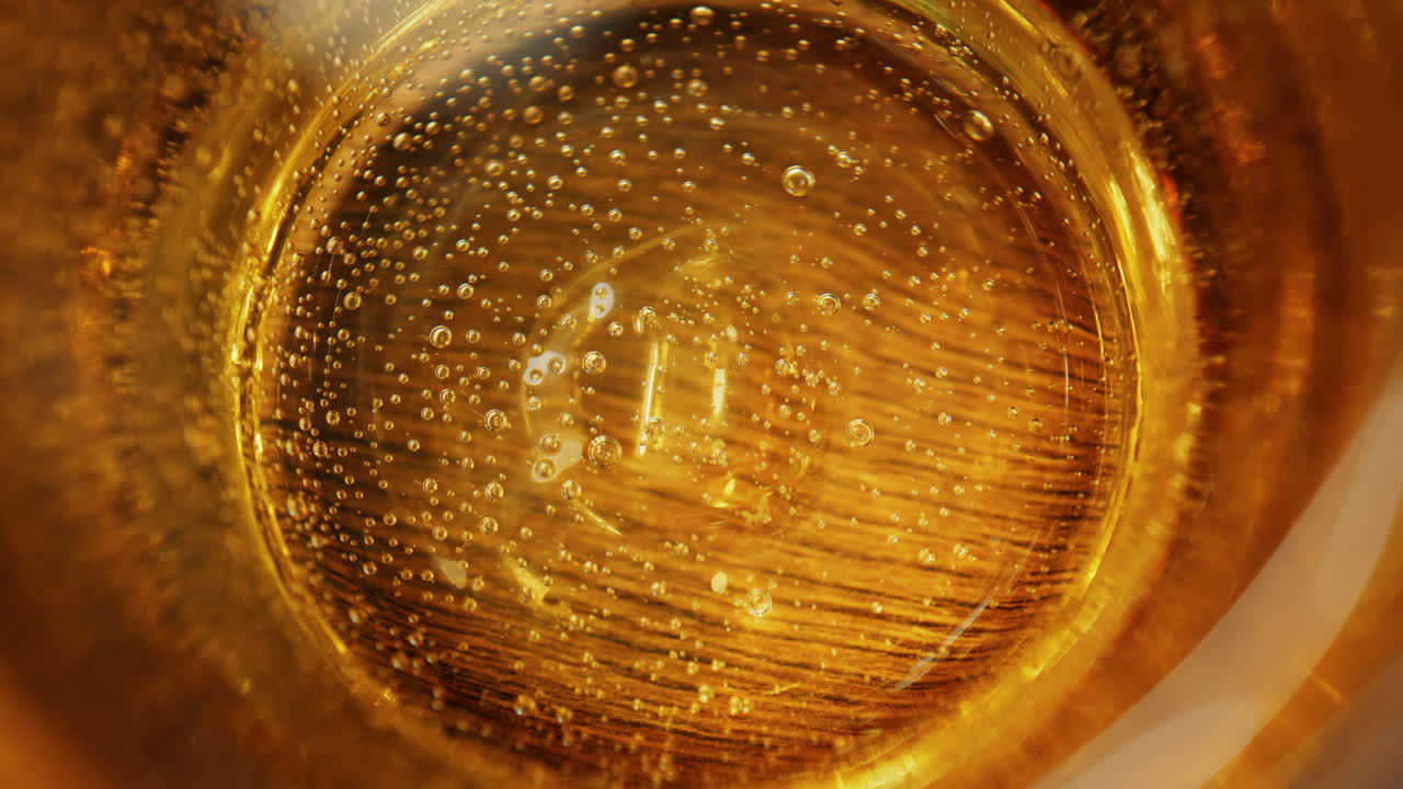 Close up of sparkling water in a yellow glass on a table at a restaurant