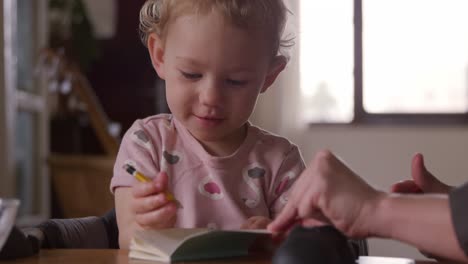 Caucasian-baby-drawing-at-home