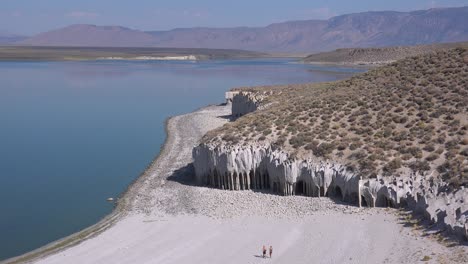 la gente camina cerca de las columnas del lago crowley y las formaciones de toba en las sierras orientales de california