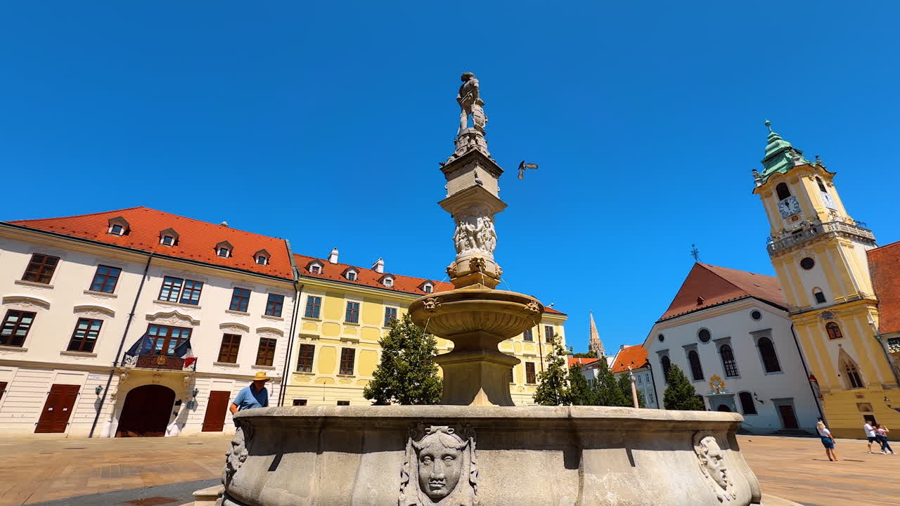 Bratislava, Slovakia, 2 June 2025: Roland Maximillian fountain on the square surrounded by the beautiful historical buildings. Sightseeing in Bratislava, Slovakia in summer