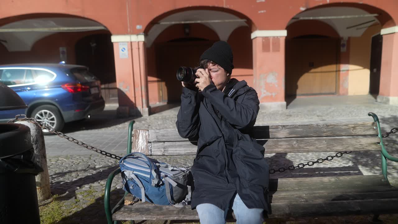 Photographer taking photos on a bench in an old European town