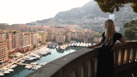 woman on vacation holiday in monaco, on overlook balcony in port of fontvielle