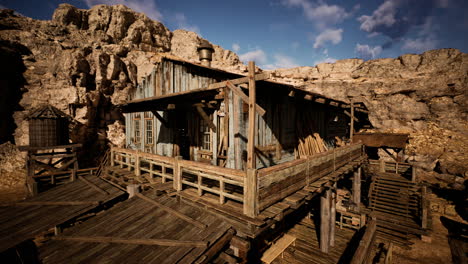 abandoned wooden structure on rocky terrain under a blue sky