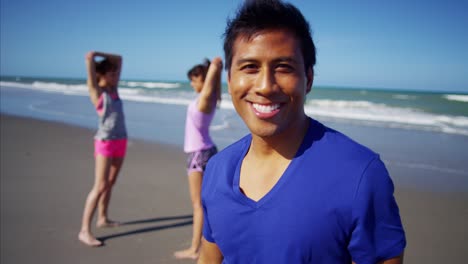 portrait of latin american male exercising on beach